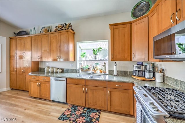 3324 Canyon Lake Dr, Las Vegas, NV 89117 - kitchen with stainless steel appliances, light wood finished floors, and brown cabinets