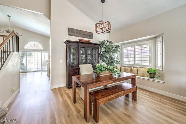 3324 Canyon Lake Dr, Las Vegas, NV 89117 - dining area featuring high vaulted ceiling, a chandelier, plenty of natural light, light wood-type flooring, and stairway