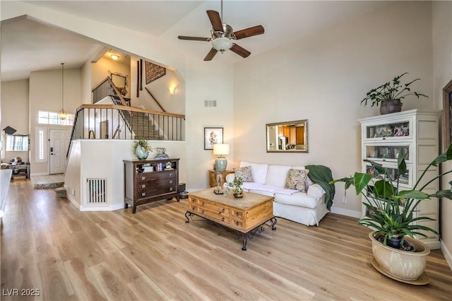 3324 Canyon Lake Dr, Las Vegas, NV 89117 - living room featuring high vaulted ceiling, ceiling fan, wood finished floors, and stairs