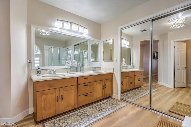 3324 Canyon Lake Dr, Las Vegas, NV 89117 - full bath with wood finished floors, double vanity, and a shower stall