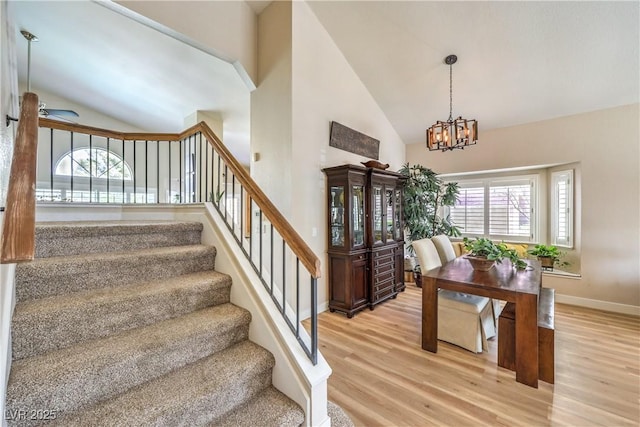 3324 Canyon Lake Dr, Las Vegas, NV 89117 - staircase featuring high vaulted ceiling, wood finished floors, a chandelier, and a ceiling fan