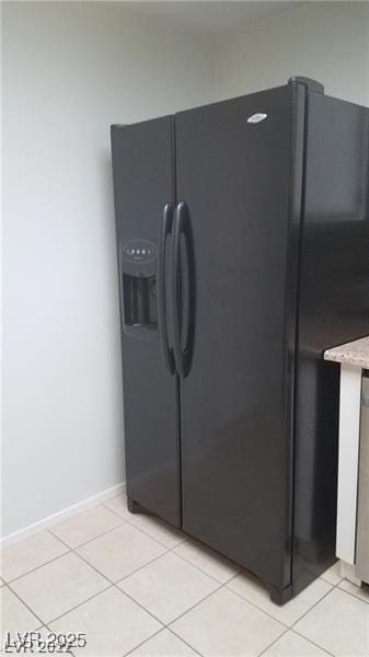 9470 Peace Way Unit 206, Las Vegas, NV 89147 - kitchen view of black refrigerator with ice dispenser and light stone counters
