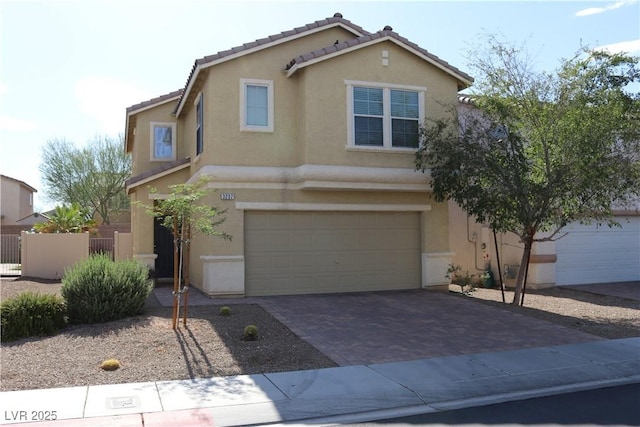 3237 Aiken St, North Las Vegas, NV 89032 - view of front of home with stucco siding, an attached garage, decorative driveway, and a tiled roof