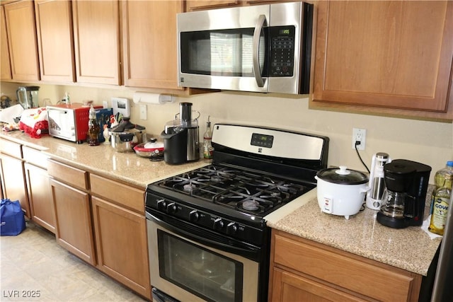 3237 Aiken St, North Las Vegas, NV 89032 - kitchen featuring appliances with stainless steel finishes and light stone counters