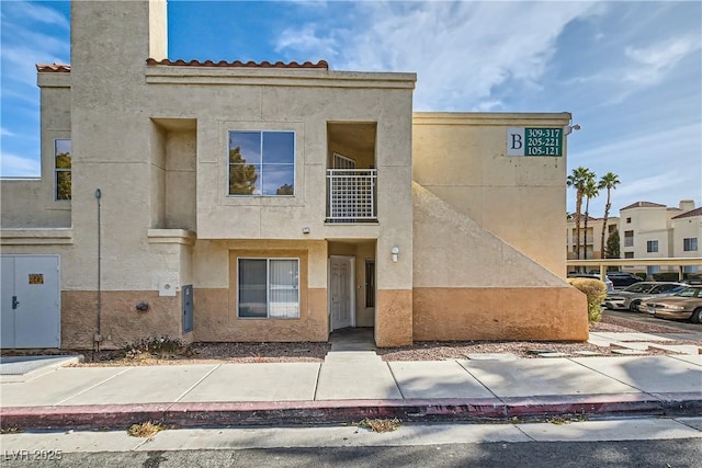 5000 Red Rock St Unit 105, Las Vegas, NV 89118 - view of front facade with stucco siding and a balcony