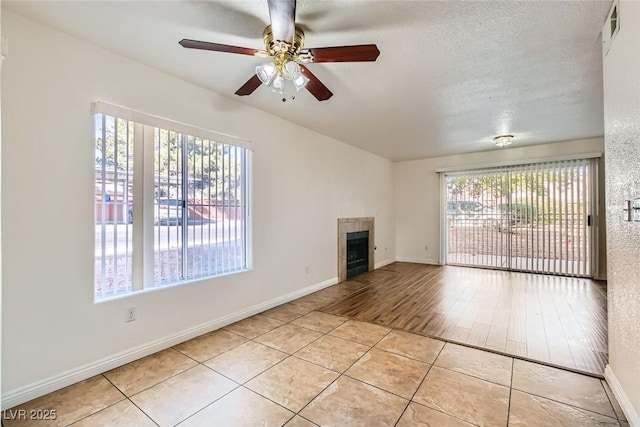 5000 Red Rock St Unit 105, Las Vegas, NV 89118 - unfurnished living room with a fireplace, ceiling fan, and light tile patterned floors