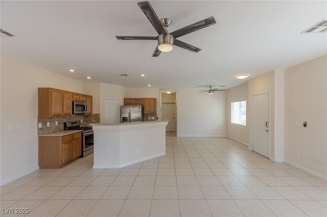 4855 Double Down Dr Unit 103, Las Vegas, NV 89122 - kitchen featuring stainless steel appliances, a ceiling fan, tasteful backsplash, light countertops, and brown cabinetry