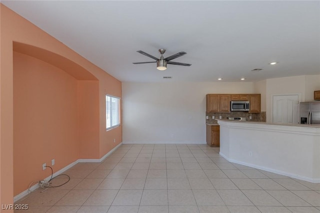 4855 Double Down Dr Unit 103, Las Vegas, NV 89122 - unfurnished living room featuring a ceiling fan, recessed lighting, arched walkways, and light tile patterned floors