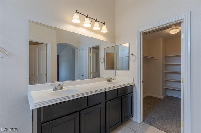 4855 Double Down Dr Unit 103, Las Vegas, NV 89122 - full bathroom featuring double vanity, tile patterned floors, and a walk in closet