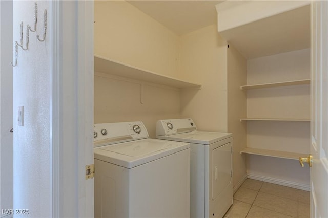 4855 Double Down Dr Unit 103, Las Vegas, NV 89122 - washroom featuring washing machine and clothes dryer and light tile patterned floors