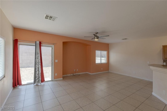 4855 Double Down Dr Unit 103, Las Vegas, NV 89122 - spare room with arched walkways, a ceiling fan, and light tile patterned floors