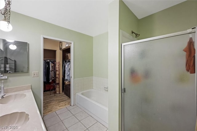 4544 Plaza De Vista St, Las Vegas, NV 89120 - full bath featuring a stall shower, a bath, tile patterned floors, double vanity, and a spacious closet
