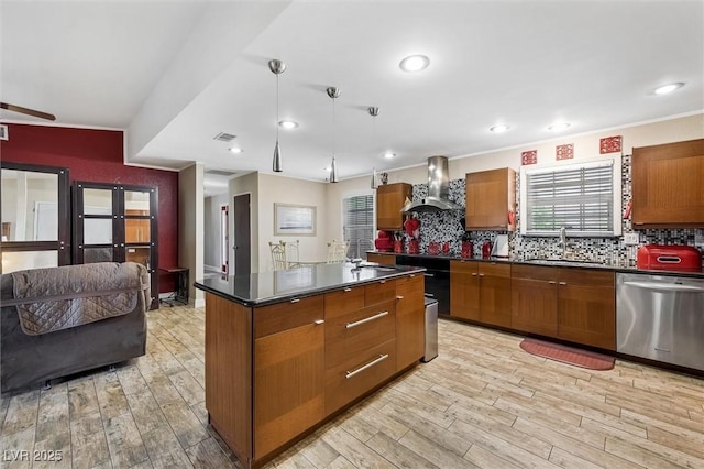 4544 Plaza De Vista St, Las Vegas, NV 89120 - kitchen with stainless steel dishwasher, wall chimney range hood, dark countertops, brown cabinets, and light wood-style floors