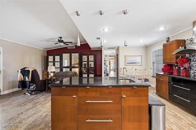 4544 Plaza De Vista St, Las Vegas, NV 89120 - kitchen with modern cabinets, light wood-type flooring, dark countertops, crown molding, and vaulted ceiling