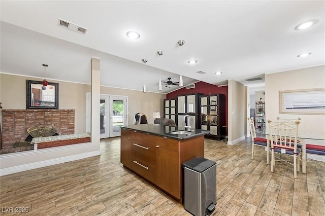 4544 Plaza De Vista St, Las Vegas, NV 89120 - kitchen with french doors, dark countertops, light wood-style floors, open floor plan, and recessed lighting