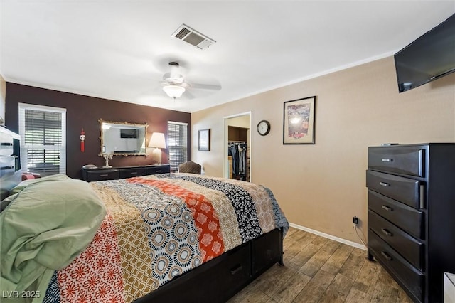 4544 Plaza De Vista St, Las Vegas, NV 89120 - bedroom featuring multiple windows, wood finished floors, a spacious closet, crown molding, and ceiling fan