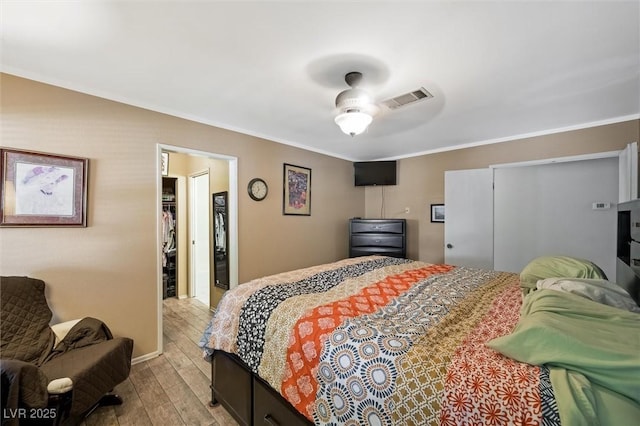 4544 Plaza De Vista St, Las Vegas, NV 89120 - bedroom with light wood finished floors, ornamental molding, a walk in closet, and a closet
