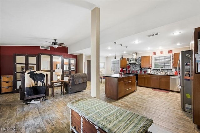 4544 Plaza De Vista St, Las Vegas, NV 89120 - kitchen featuring wall chimney range hood, light wood finished floors, appliances with stainless steel finishes, open floor plan, and recessed lighting