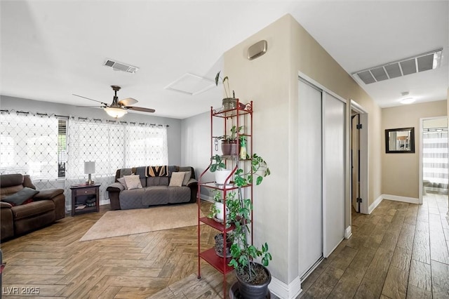 4544 Plaza De Vista St, Las Vegas, NV 89120 - living room with a ceiling fan, attic access, and parquet floors