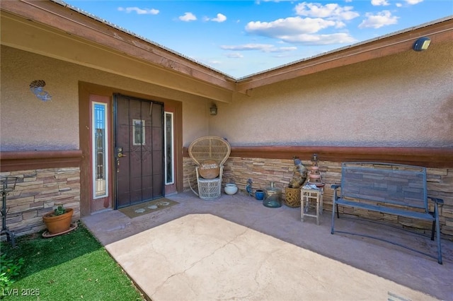 4544 Plaza De Vista St, Las Vegas, NV 89120 - entrance to property featuring stone siding, stucco siding, and a patio