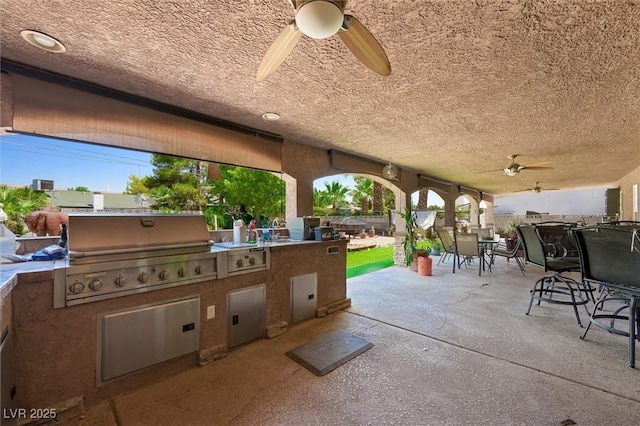 4544 Plaza De Vista St, Las Vegas, NV 89120 - view of patio with ceiling fan, outdoor dining area, and an outdoor kitchen