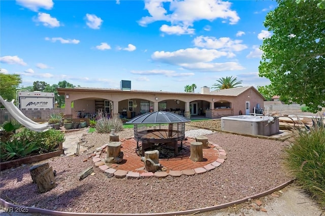 4544 Plaza De Vista St, Las Vegas, NV 89120 - back of house featuring a hot tub, a patio, and stucco siding