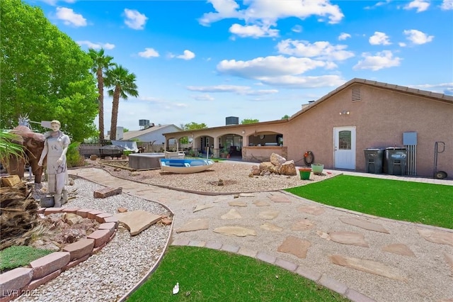 4544 Plaza De Vista St, Las Vegas, NV 89120 - rear view of house with a patio, a hot tub, and stucco siding