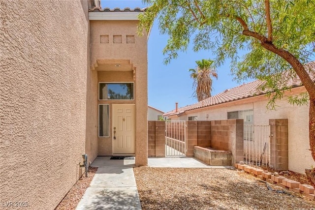 3664 Summer Picnic Ct, Las Vegas, NV 89147 - doorway to property with stucco siding, a tile roof, and a gate