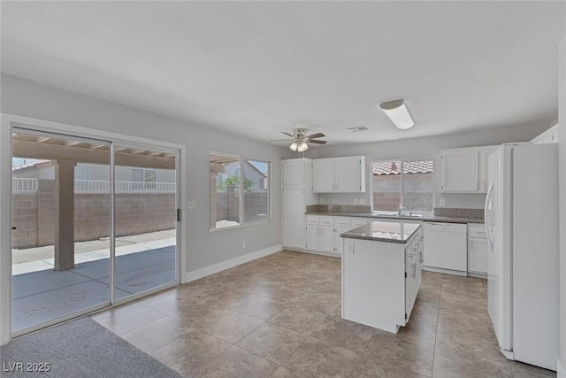 3664 Summer Picnic Ct, Las Vegas, NV 89147 - kitchen featuring white appliances, white cabinetry, a kitchen island, a ceiling fan, and light tile patterned floors