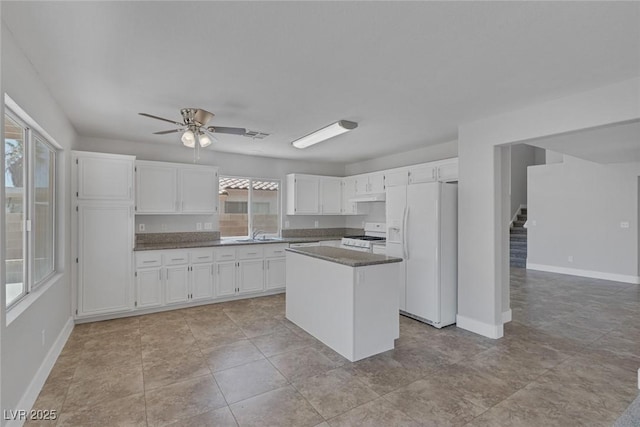 3664 Summer Picnic Ct, Las Vegas, NV 89147 - kitchen featuring white appliances, white cabinetry, ceiling fan, a center island, and under cabinet range hood