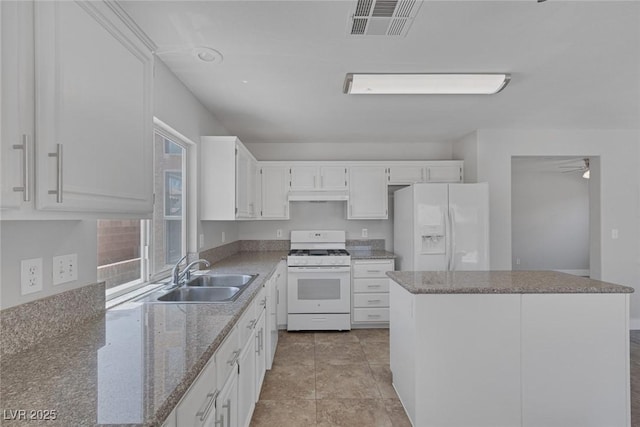 3664 Summer Picnic Ct, Las Vegas, NV 89147 - kitchen featuring white appliances, under cabinet range hood, a center island, white cabinets, and light stone counters