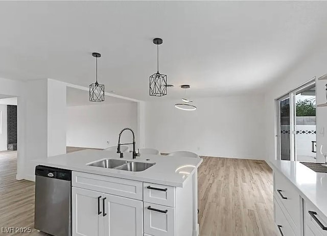 5321 Westleigh Ave, Las Vegas, NV 89146 - kitchen with stainless steel dishwasher, light countertops, light wood-type flooring, and decorative light fixtures