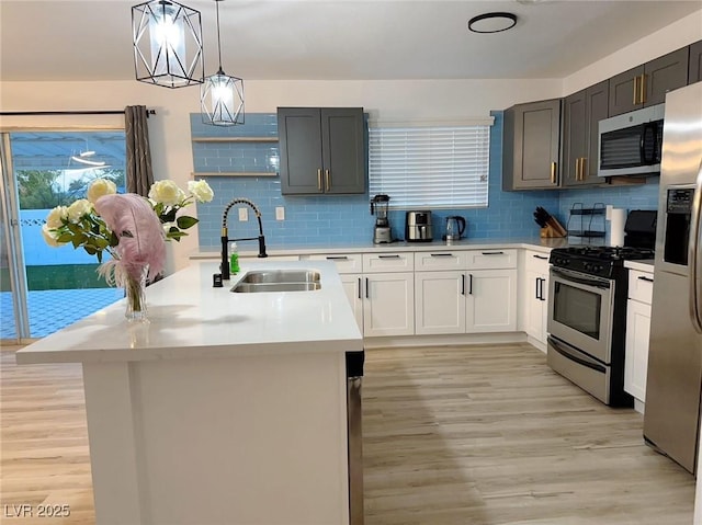 5321 Westleigh Ave, Las Vegas, NV 89146 - kitchen featuring appliances with stainless steel finishes, light countertops, light wood-style flooring, and tasteful backsplash
