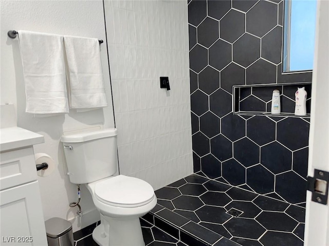 5321 Westleigh Ave, Las Vegas, NV 89146 - bathroom with vanity, a tile shower, and tile patterned floors