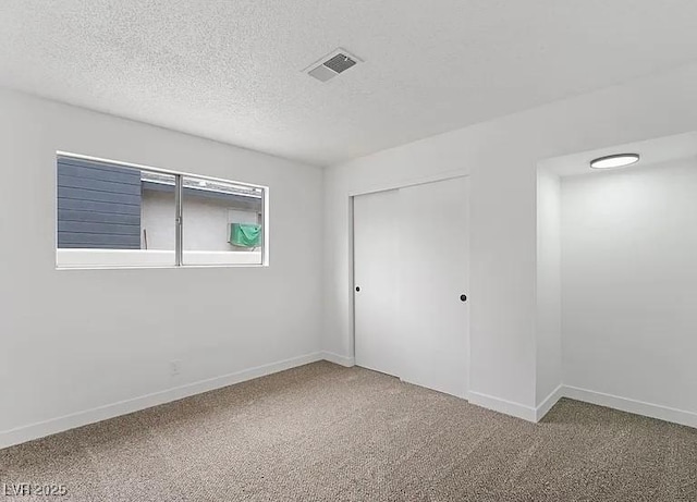 5321 Westleigh Ave, Las Vegas, NV 89146 - unfurnished bedroom with carpet, a closet, and a textured ceiling