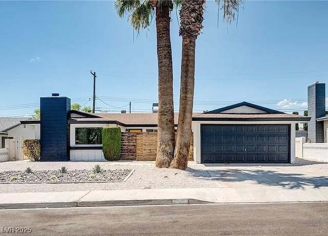 5321 Westleigh Ave, Las Vegas, NV 89146 - mid-century modern home with driveway, an attached garage, and a chimney