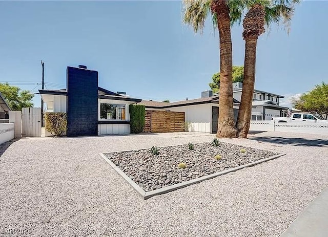 5321 Westleigh Ave, Las Vegas, NV 89146 - view of front facade featuring a chimney and a gate