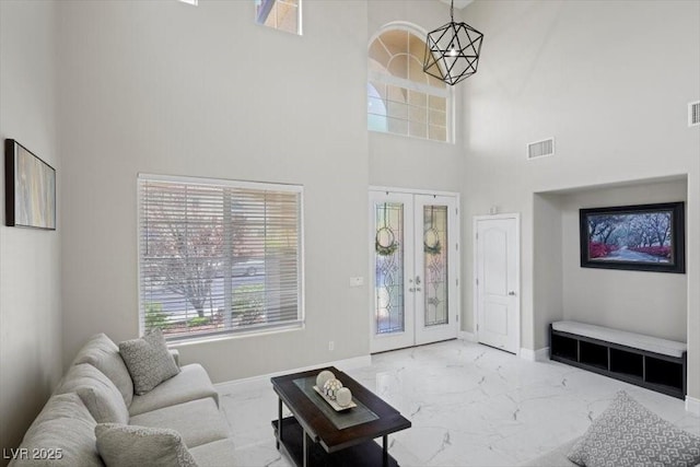 7012 Geese Gathering St, North Las Vegas, NV 89084 - living room with a towering ceiling, marble finish flooring, and french doors