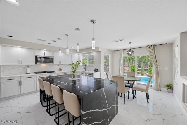 7012 Geese Gathering St, North Las Vegas, NV 89084 - dining area with light marble finish floors and plenty of natural light