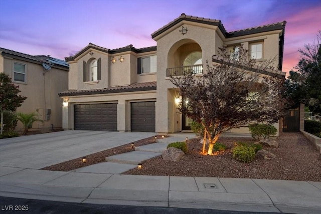 7012 Geese Gathering St, North Las Vegas, NV 89084 - mediterranean / spanish home with a tile roof, an attached garage, stucco siding, driveway, and a balcony