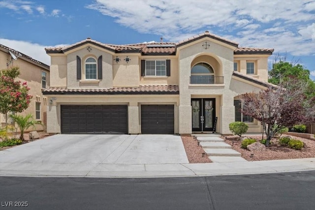 7012 Geese Gathering St, North Las Vegas, NV 89084 - mediterranean / spanish house featuring an attached garage, a tile roof, stucco siding, and solar panels