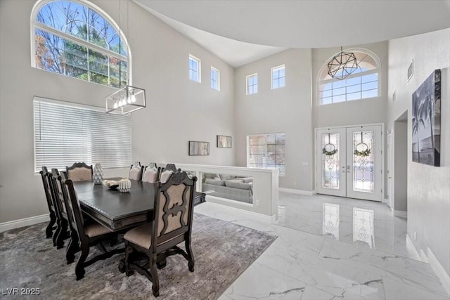 7012 Geese Gathering St, North Las Vegas, NV 89084 - dining space with a high ceiling, french doors, marble finish floors, and a chandelier