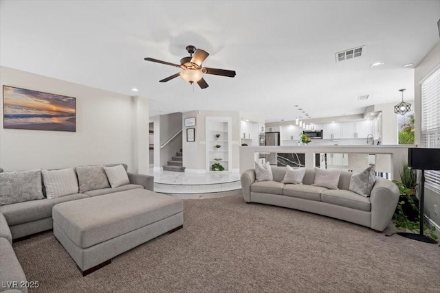 7012 Geese Gathering St, North Las Vegas, NV 89084 - carpeted living room with ceiling fan, stairway, and recessed lighting
