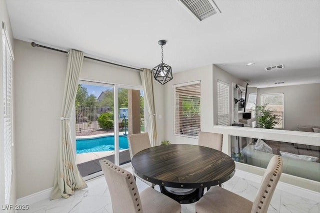 7012 Geese Gathering St, North Las Vegas, NV 89084 - dining area featuring light marble finish flooring and baseboards