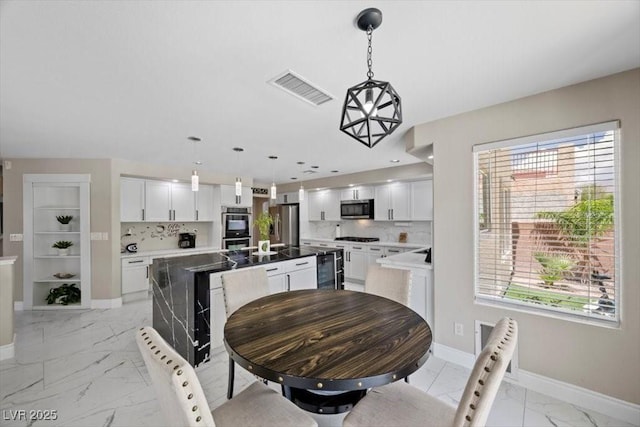 7012 Geese Gathering St, North Las Vegas, NV 89084 - dining area with light marble finish floors, healthy amount of natural light, and beverage cooler