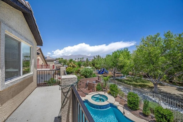 7012 Geese Gathering St, North Las Vegas, NV 89084 - view of pool with an in-ground hot tub and a mountain view
