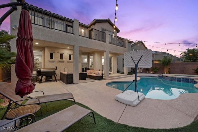 7012 Geese Gathering St, North Las Vegas, NV 89084 - view of swimming pool with outdoor lounge area, a patio area, a fenced backyard, and a pool with connected hot tub