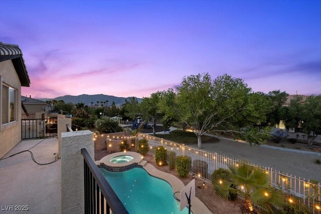 7012 Geese Gathering St, North Las Vegas, NV 89084 - view of pool featuring a patio area, an in-ground hot tub, a fenced backyard, and a mountain view