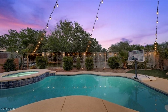 7012 Geese Gathering St, North Las Vegas, NV 89084 - pool at dusk with a pool with connected hot tub