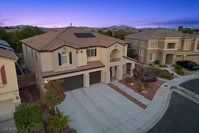 7012 Geese Gathering St, North Las Vegas, NV 89084 - mediterranean / spanish-style home featuring a garage, solar panels, a tile roof, and stucco siding